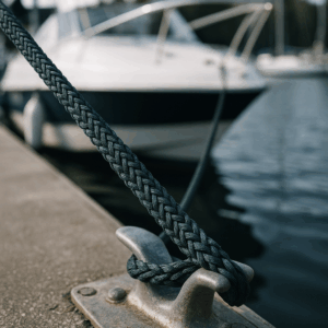 8-strand NAVIRA PA Moor 8 rope tied around a marina cleat, securing a vessel.