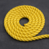 Coiled yellow 8-strand polyester sinking mooring rope used for marina and boat docking.