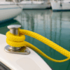 ROPIRA PP Float Moor – Floating Rope in Use Yellow floating PP double braid rope secured on a stainless steel cleat on a boat deck in a marina.