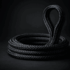 Close-up of a black sinking polyester mooring rope looped around a stainless-steel cleat on a boat.